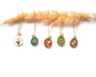 May include: Five gold necklaces with enamel flower pendants. Each pendant features a different flower design in various colors, including white, pink, red, green, and purple.