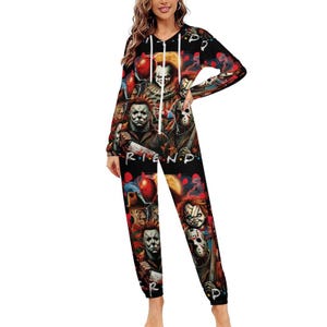 May include: Black jumpsuit featuring a collage of horror movie characters, including Pennywise, Michael Myers, and Jason Voorhees. The word "FRIENDS" is printed on the front. The long-sleeved outfit has a hood and a zipper.