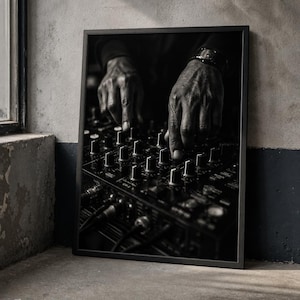May include: A black and white framed wall art print depicting a close-up of two hands adjusting the knobs and faders on a professional audio mixing console. The image captures the intricate details of the equipment and the texture of the hands.
