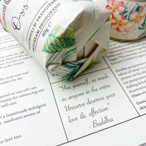 May include: A white and green wrapped bar of natural deodorant with the text "Patchouli & Frangipani Oatcream Deodorant 40g e" printed on the wrapper. The quote "You yourself, as much as anyone in the entire Universe deserves your love & affection" - Buddha is printed on a white background.