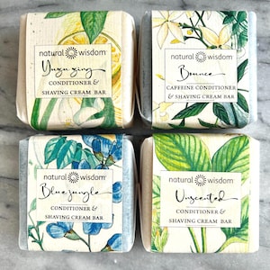 May include: Four bars of natural conditioner and shaving cream, each with a different scent and botanical illustration. The scents are Yuzu Zing, Bounce, Blue Jungle, and Unscented.
