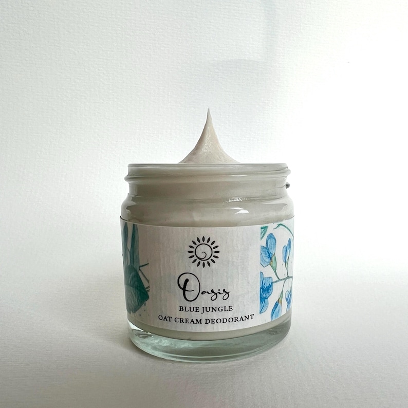 May include: A white jar of Oasis Blue Jungle Oat Cream Deodorant with a blue and green floral design on the label.