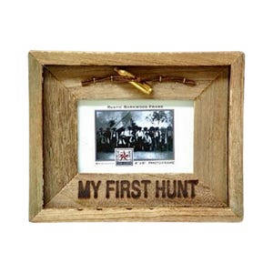 May include: A rustic wooden photo frame with a 4x6 inch opening. The frame has a brown finish and features a wire and bullet accent. The frame has the words "My First Hunt" engraved on the bottom.