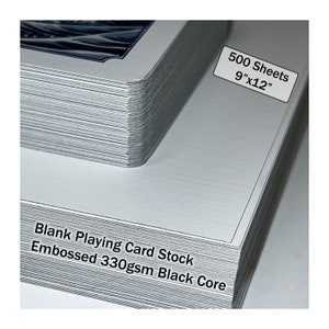 May include: A stack of 500 blank playing card stock sheets, 9 inches by 12 inches, with a black core and embossed 330gsm paper.
