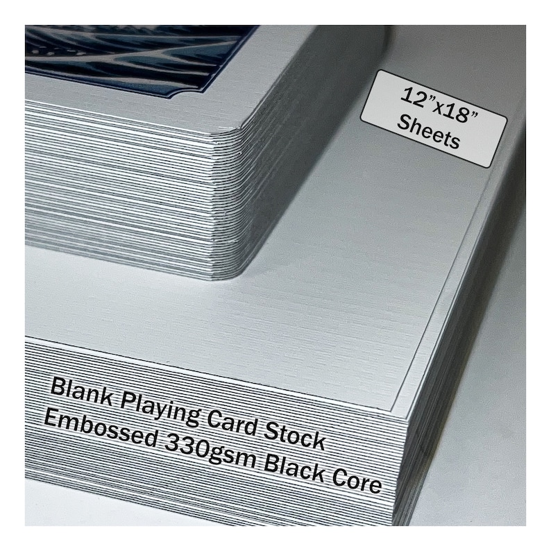 May include: A stack of 30.5cm x 45.7cm blank playing card stock sheets. The sheets are embossed and have a black core. The paper is 330gsm.