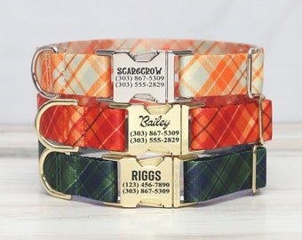 May include: Three dog collars with personalized metal tags. The top collar is orange and white plaid with the name "SCARGGROW" and phone numbers. The middle collar is red and orange plaid with the name "Bailey" and phone numbers. The bottom collar is green and black plaid with the name "RIGGS" and phone numbers.