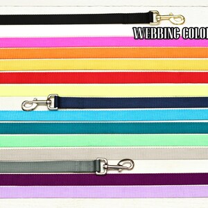 May include: A range of webbing colours for dog leads, including black, white, pink, orange, yellow, red, pale yellow, navy blue, light blue, teal, light green, grey, purple, and lavender. "Webbing Color Options" is written at the top of the image.