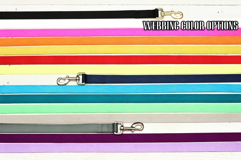 May include: A range of webbing colours for dog leads, including black, white, pink, orange, yellow, red, pale yellow, navy blue, light blue, teal, light green, grey, purple, and lavender. "Webbing Color Options" is written at the top of the image.