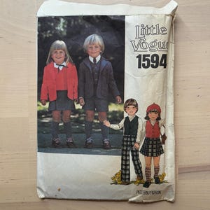 May include: Vintage Little Vogue sewing pattern envelope. The envelope shows a colour photograph of children wearing outfits that can be made from the pattern. The text "Little Vogue 1594" is printed on the envelope.