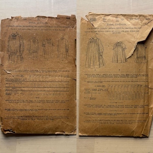 Puede incluir: Dos sobres de patrones de costura vintage. Los sobres marrones presentan ilustraciones de vestidos de niña y texto. El texto incluye el precio, el número de patrón e instrucciones. Los sobres están rotos y desgastados.