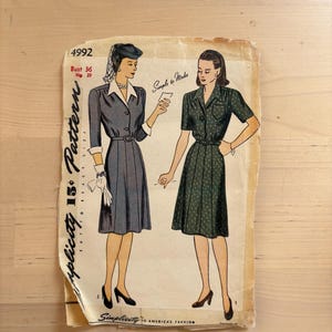 May include: Vintage Simplicity pattern featuring illustrations of two dresses. The pattern includes the number 4992, bust size 36 inches, and hip size 39 inches. The text "Simple to Make" is also visible. The pattern is printed on aged paper.