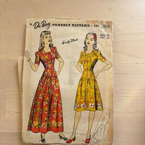 May include: Vintage Du Barry Perfect Pattern 5530. The pattern features illustrations of two dresses with floral designs. The text "Easily Made" is visible. The pattern is on aged paper.