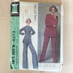 May include: A vintage McCall's 4273 sewing pattern envelope for a Halston design featuring an unlined jacket and pants. The cover displays illustrations of the two-piece outfit in blue and red, with text including the pattern number 4273 and size 14.