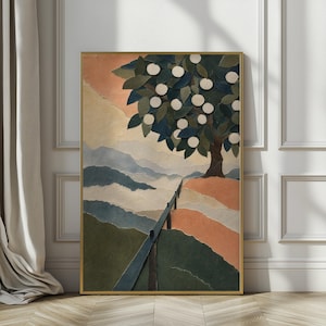 May include: A framed wall art piece featuring a layered paper collage of a landscape. The scene depicts a tree with white circular fruit, dark green leaves, and a brown trunk, set against rolling hills in shades of peach, blue, and green.