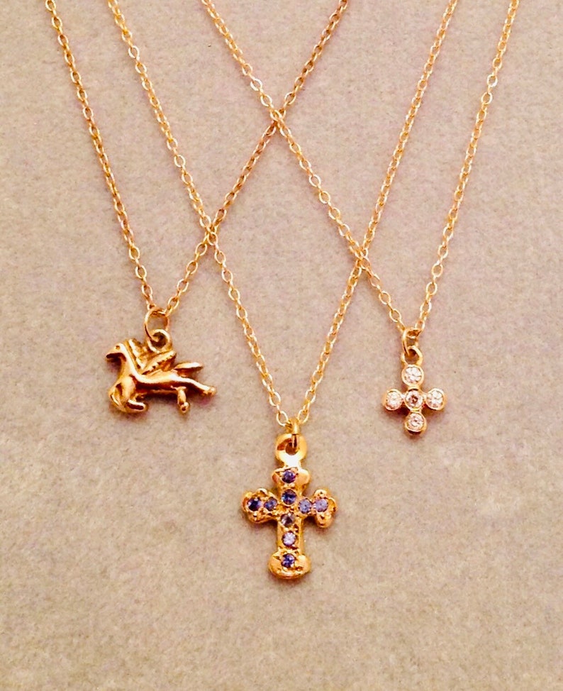 precious tiny little crosses and Pegasus like 14 karat gold Sweet