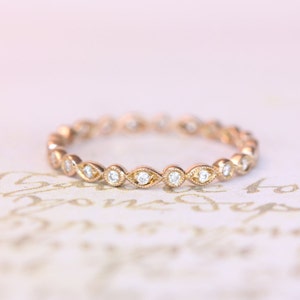 14kt. diamond rose gold band with a miligrain edge
