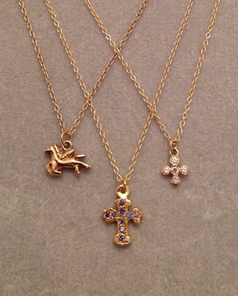 precious tiny little crosses and Pegasus like 14 karat gold Sweet