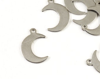May include: A pile of silver metal crescent moon charms with a hole at the top for attaching to jewelry or other crafts.