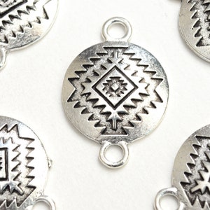 May include: Silver-toned metal charms with a geometric design. Each charm has two loops for attaching to jewelry or other crafts.