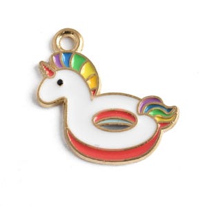 May include: A gold-toned metal charm in the shape of a unicorn floatie. The unicorn has a white body, a rainbow mane and tail, and a red horn. The floatie has a red and white ring design.