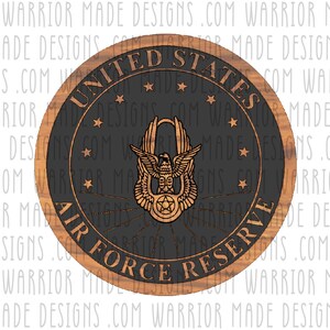May include: A round wooden plaque with a black background and a gold eagle emblem. The plaque reads "United States Air Force Reserve".