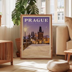 a framed poster of Prague, Czech Republic, with a nighttime view of the Old Town and the Prague Castle, which is illuminated by lights.