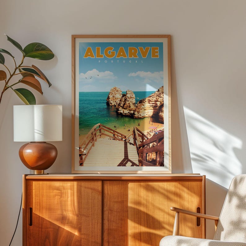 a framed poster of a beach scene with a wooden staircase leading to a cliff, set against a blue sky with clouds.