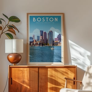 a framed poster of the Boston skyline, with a boat visible in the water below.
