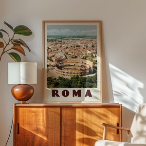 a framed poster of the Colosseum in Rome, Italy, displayed on a wooden cabinet.