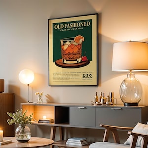 a poster of an old-fashioned cocktail hanging on a wall in a living room.