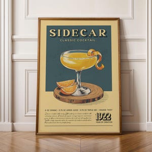 The image is a framed poster advertising a cocktail called "Sidecar Classic Cocktail". The poster features an illustration of a cocktail glass with a lemon twist and orange peel, along with text describing the ingredients and the year of creation, which is the year 1920.