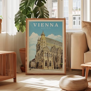 a framed poster of the St. Peter's Basilica in Vienna, Austria, displayed in a living room setting with a large window and a potted plant in the background.