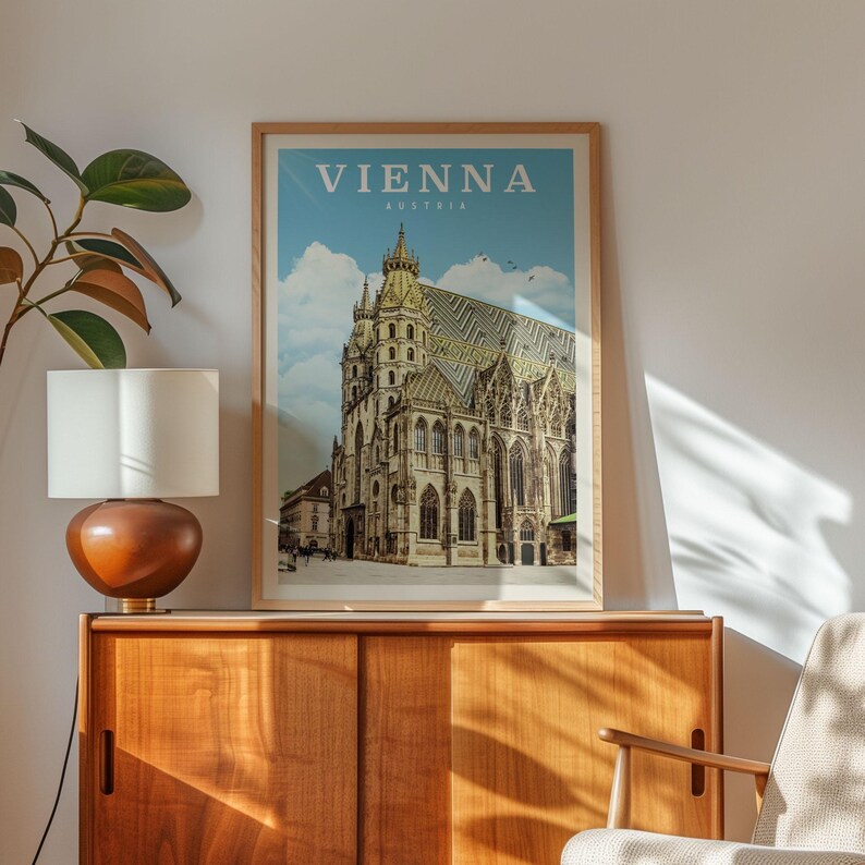 a framed poster of the St. Peter's Basilica in Vienna, Austria, displayed on a wooden cabinet.