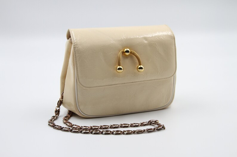 cream patent clutch bag