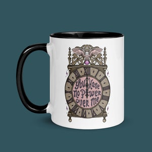 May include: White ceramic mug with a black rim. The mug features a clock face with the words "You Have No Power Over Me" and an owl perched on top.