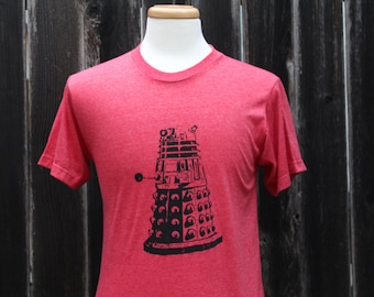 May include: Red t-shirt with a black and white graphic of a Dalek from Doctor Who.