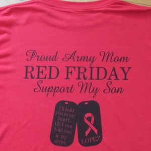 May include: Red t-shirt with the text "Proud Army Mom Red Friday Support My Son" and two dog tags with the text "I'll hold you in my heart, till I can hold you in my arms" and "LOPEZ".