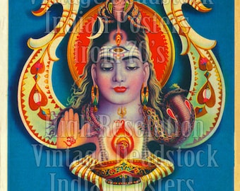 May include: Vintage Indian poster of Shiva Jothi. The image shows a serene figure with a third eye, a cobra, and detailed ornamentation. The background is a vibrant blue with decorative patterns and text.