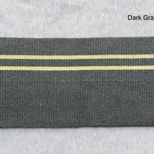 May include: Dark gray elastic with two thin yellow stripes.  The elastic is ribbed.