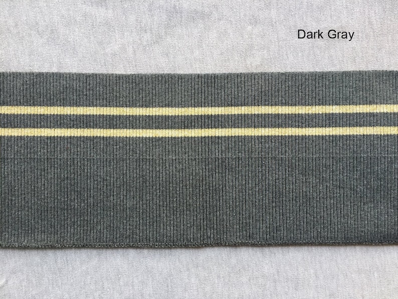 May include: Dark gray elastic with two thin yellow stripes.  The elastic is ribbed.