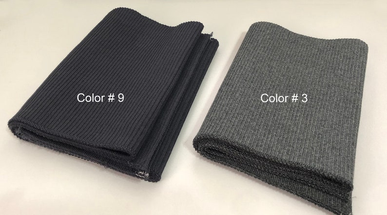 May include: Two rolls of ribbed fabric, one black and one gray. The black fabric is labeled "Color # 9" and the gray fabric is labeled "Color # 3".