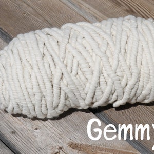 May include: A large skein of white yarn, perfect for crocheting or knitting. The yarn is thick and fluffy, and it has a soft, natural texture.