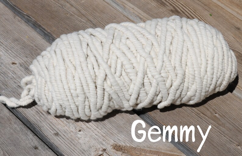 May include: A large skein of white yarn, perfect for crocheting or knitting. The yarn is thick and fluffy, and it has a soft, natural texture.