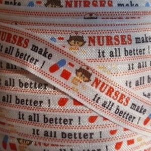 May include: White elastic ribbon with a repeating pattern of red and white pills, cartoon nurses, and the text "NURSES make it all better!"