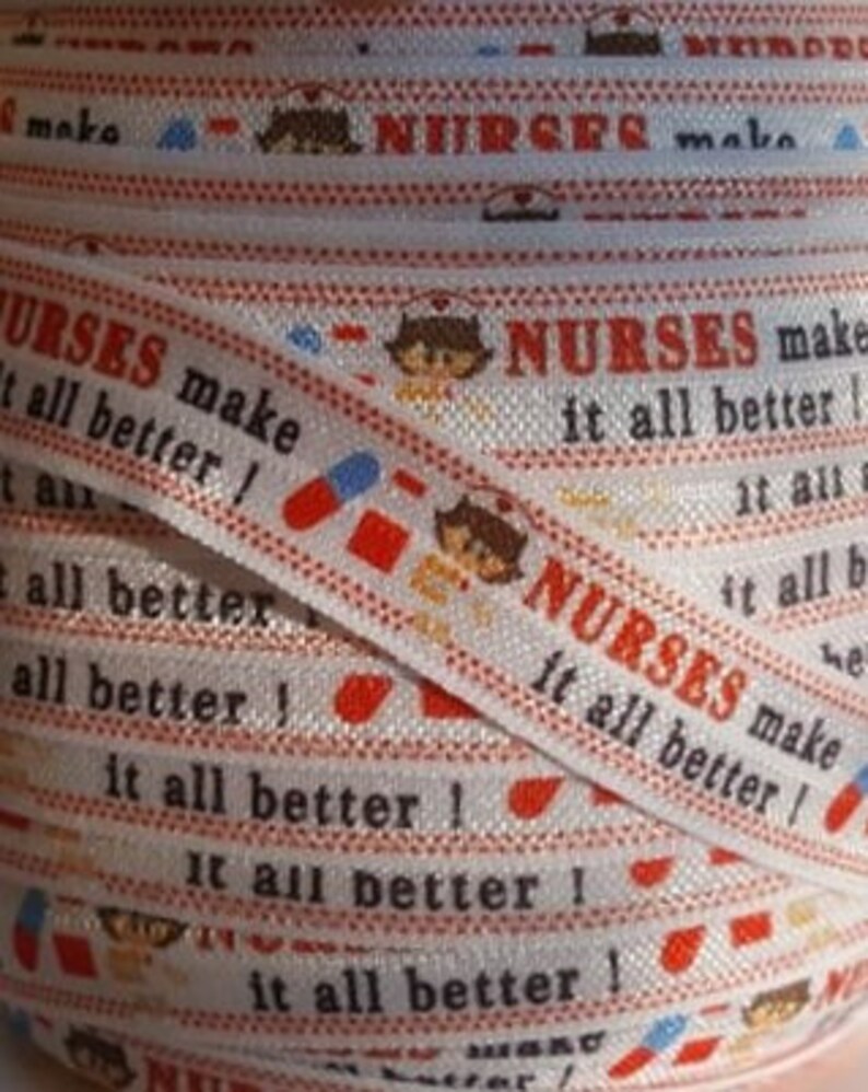 May include: White elastic ribbon with a repeating pattern of red and white pills, cartoon nurses, and the text "NURSES make it all better!"