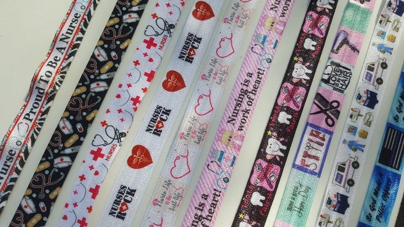 May include: Assortment of colorful ribbon with various designs and text, including "Nurse Proud To Be A Nurse", "Nurses Rock", "Nursing is a work of heart!" and "Love Hair".