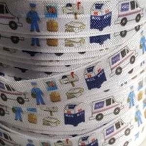 May include: White elastic ribbon with a repeating pattern of mail trucks, mailboxes, letters, and a mail carrier.