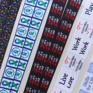 May include: Five different ribbon designs with text printed on them. The ribbons are black, white, and blue. The text on the ribbons includes "You'll Never Walk Alone", "Play", "Work", "Live", and "Skills for Life".