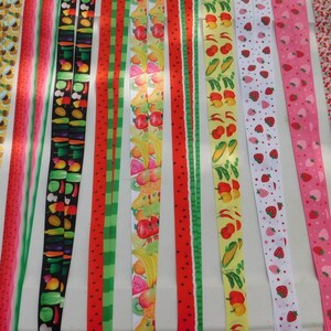 May include: Assortment of colorful fabric ribbon with various fruit prints, including watermelon, strawberries, oranges, pineapples, and peppers.