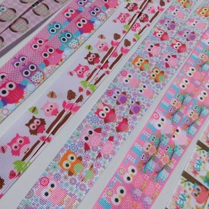 May include: Several patterned ribbons featuring owl designs in pink, blue, and brown. The ribbons display various patterns, including polka dots, floral motifs, and owl illustrations. The ribbons are arranged diagonally, showcasing the different designs.